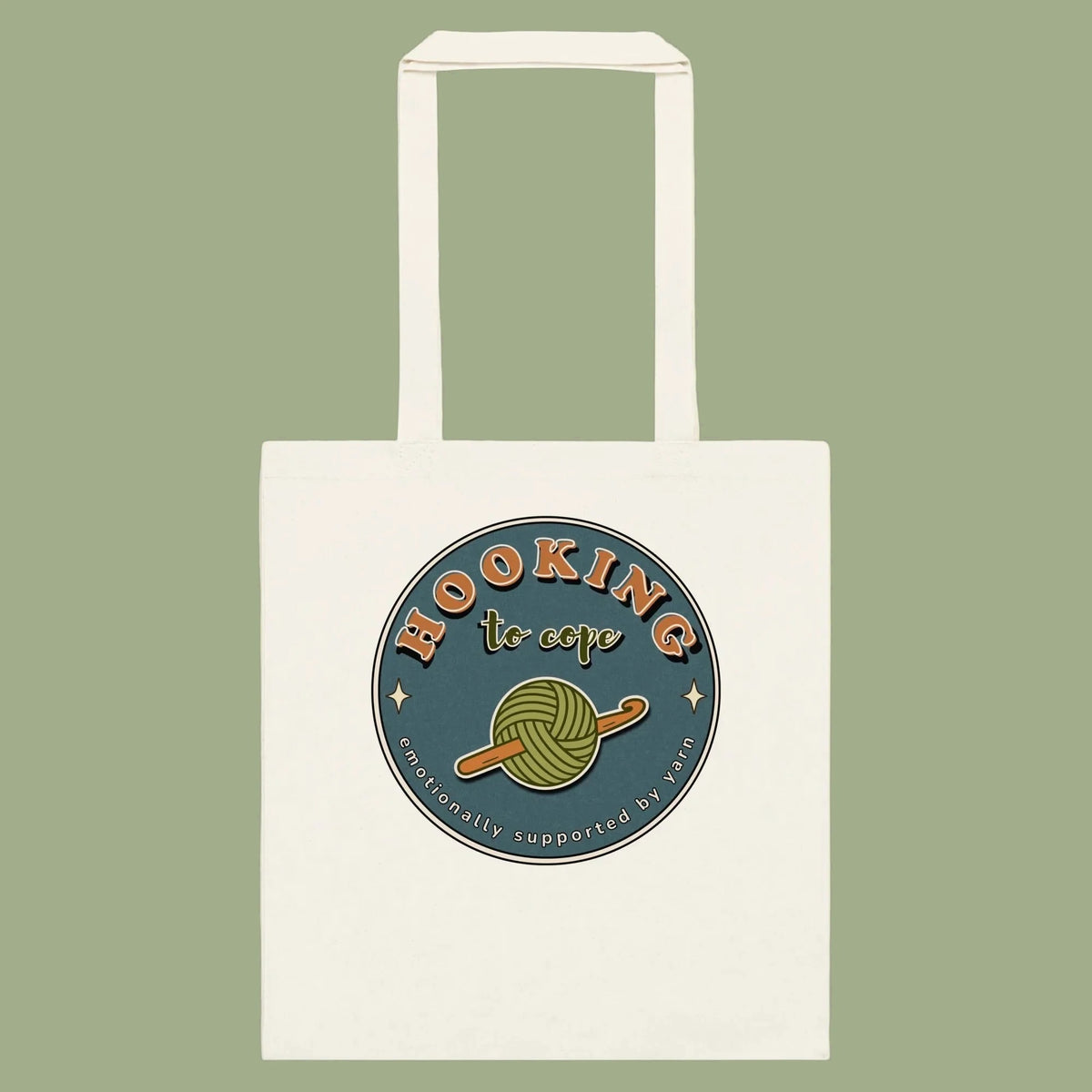 Natural cotton tote bag with Hooking to Cope crochet badge artwork