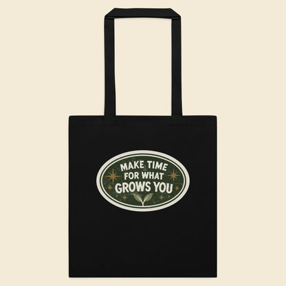 Black cotton tote bag with Make Time for What Grows You artwork