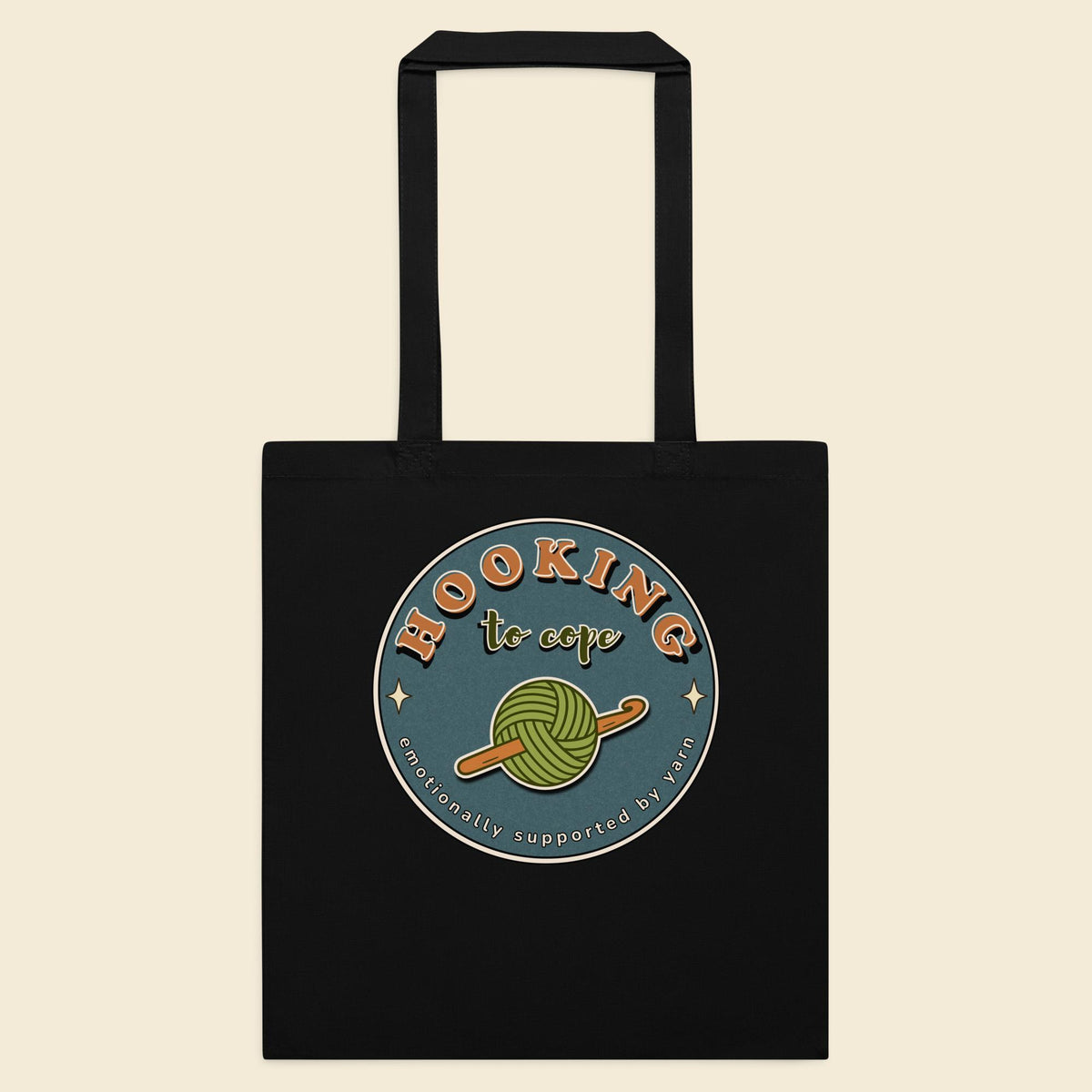 Black cotton tote bag with Hooking to Cope crochet badge artwork