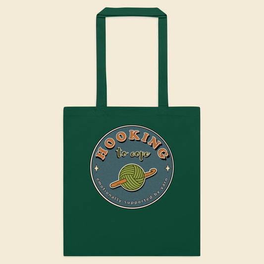 Bottle green cotton tote bag with Hooking to Cope crochet badge artwork