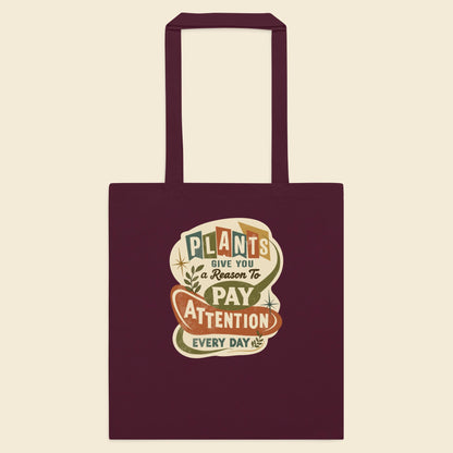 Burgundy cotton tote bag with Plants Give You a Reason artwork