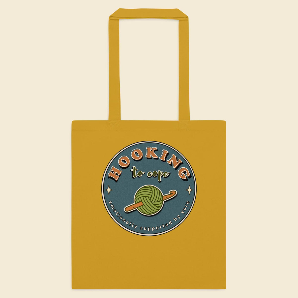 Mustard cotton tote bag with Hooking to Cope crochet badge artwork