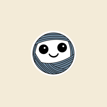Boggle, a wide-eyed dusty blue Yarn Creature magnet, 3 × 3 in, on a cream background