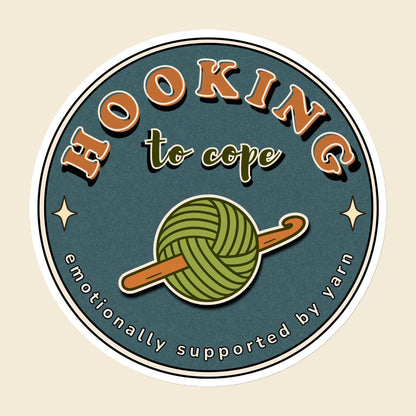 Hooking to Cope round crochet badge magnet with a yarn ball and hook, 6 × 6 in