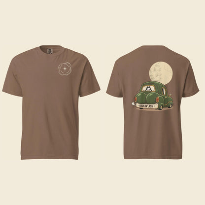 Front and back of an espresso heavyweight T-shirt: a small cream vortex on the chest and Haulin’ Ash artwork of a green car under a full moon on the back