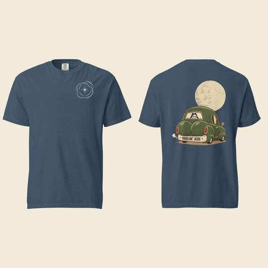 Front and back of a midnight blue heavyweight T-shirt: a small cream vortex on the chest and Haulin’ Ash artwork of a green car under a full moon on the back