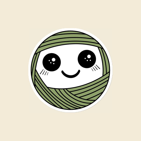 Pip, a sparkly-eyed, blushing sage green Yarn Creature magnet, 4 × 4 in, on a cream background