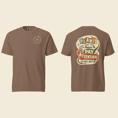 Front and back of an espresso heavyweight T-shirt: a small cream logo mark on the chest and Plants Give You a Reason artwork on the back