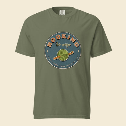 Moss heavyweight T-shirt with Hooking to Cope crochet badge artwork