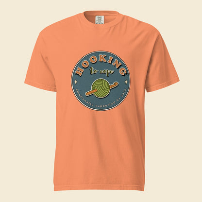Terracotta heavyweight T-shirt with Hooking to Cope crochet badge artwork